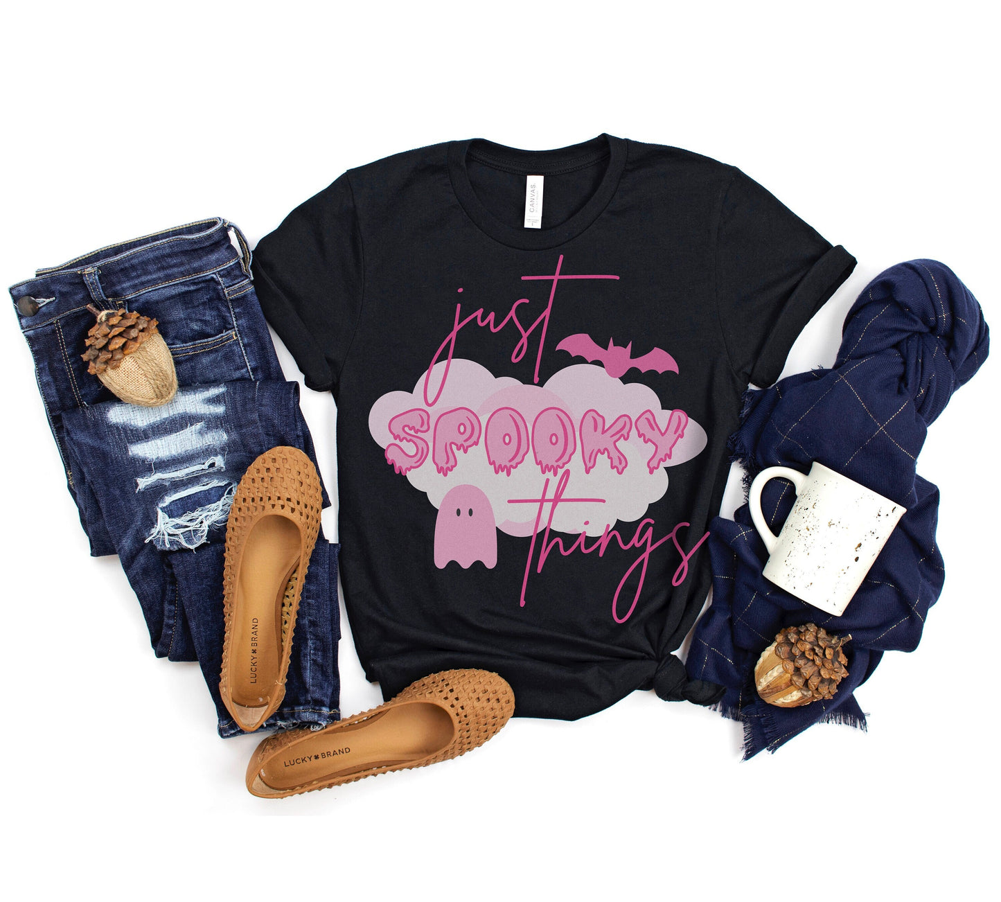 A black T-shirt that reads &quot;just spooky things&quot; in pink cursive font. &quot;Spooky&quot; in in Pink drippy letters. Design features a little pink ghost and a pink bat.