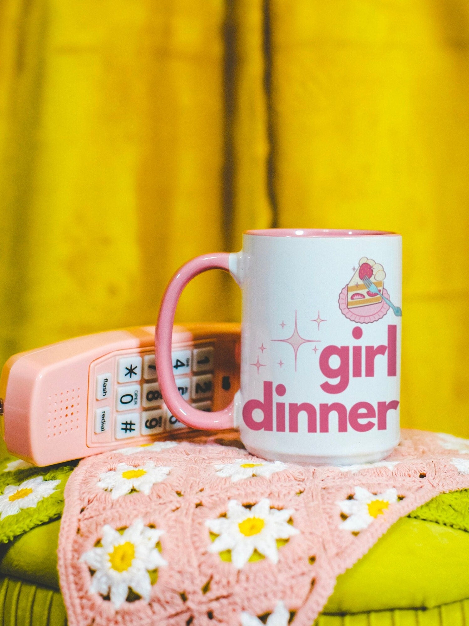 A White and Pink mug that reads &quot;Girl Dinner&quot;. Design features Pink lowercase fonts and a slice of Kawaii strawberry cake.