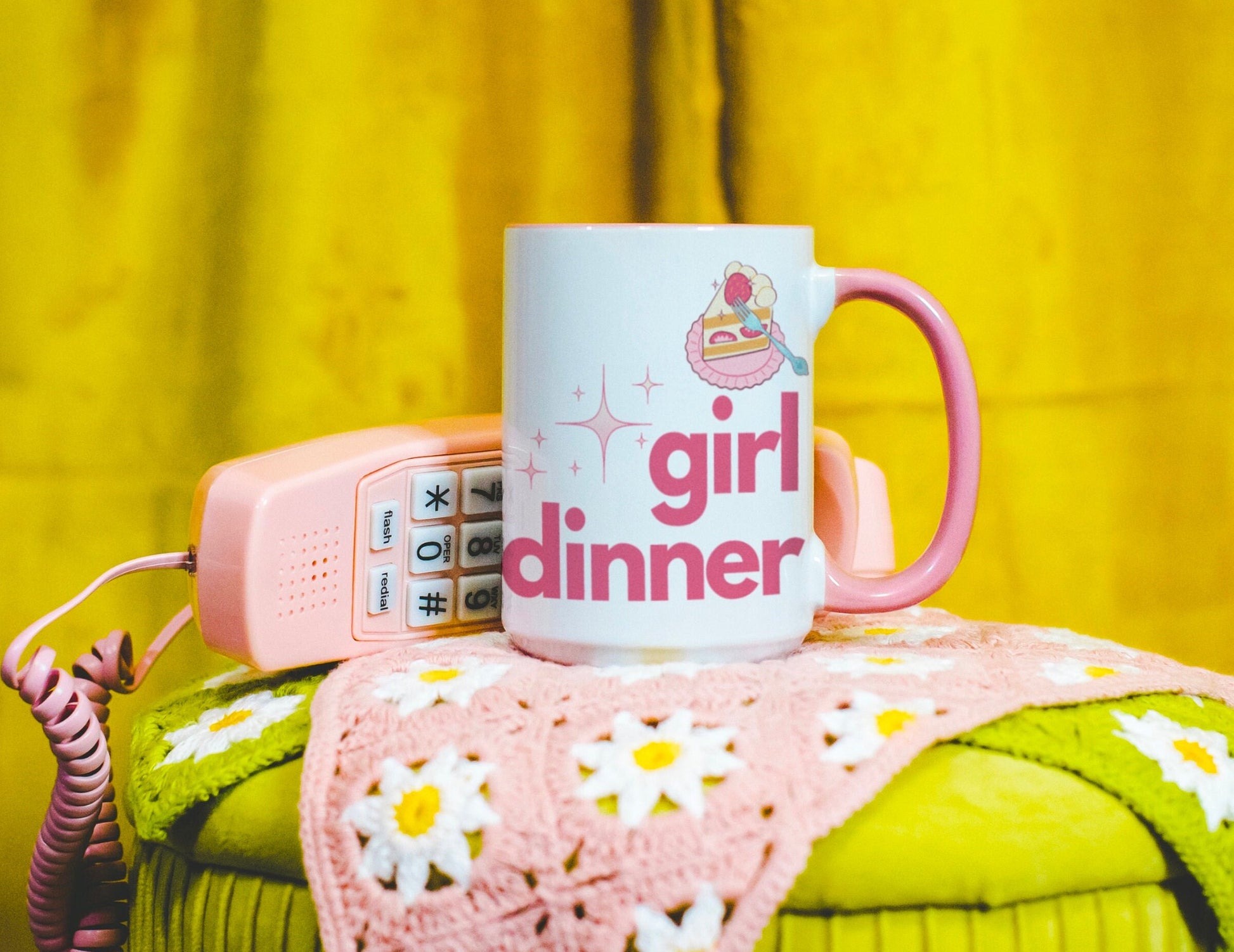 A White and Pink mug that reads &quot;Girl Dinner&quot;. Design features Pink lowercase fonts and a slice of Kawaii strawberry cake.