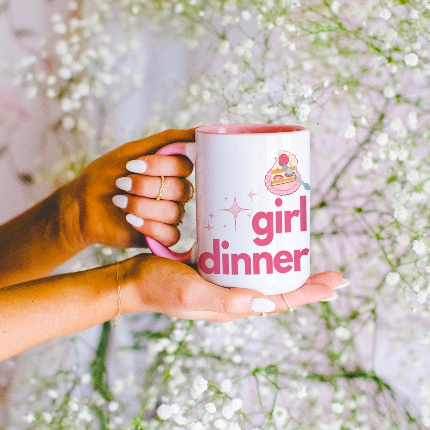 A White and Pink mug that reads &quot;Girl Dinner&quot;. Design features Pink lowercase fonts and a slice of Kawaii strawberry cake.